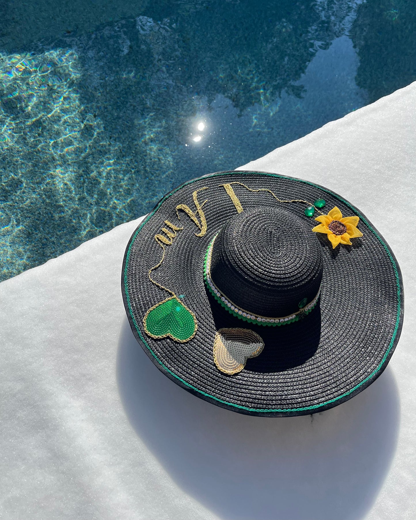 Manifest Hat handcrafted luxury hat with embroidery and crystal details, photographed in winter snow